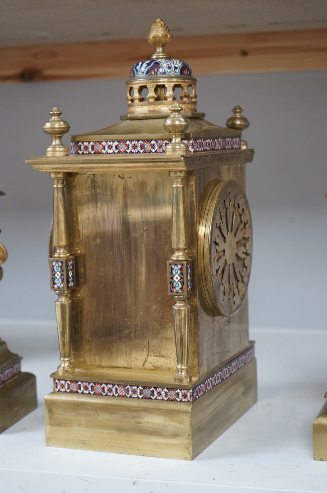 A large early 20th century French brass and champlevé enamel clock garniture, 35cm high